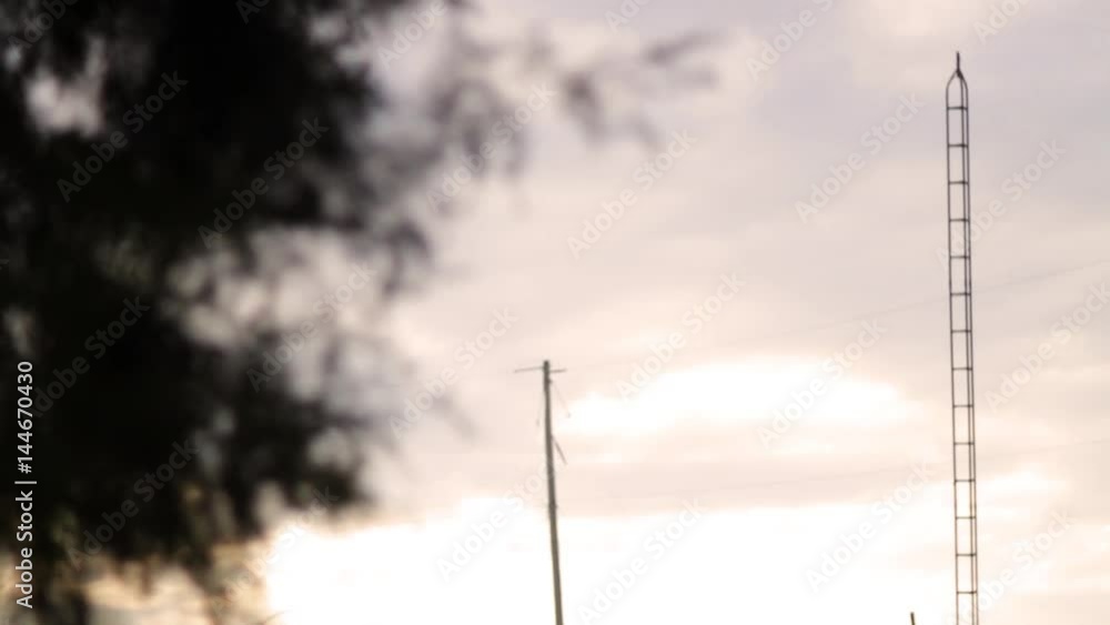 Old antenna pole in field at sunset on golden day Old antenna pole in field at sunset on golden day
