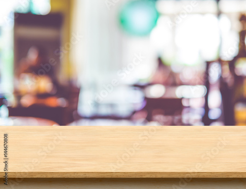 Empty wooden brown table top at blur restaurant background with bokeh light  Mock up template for display or montage of product Food Business presentation