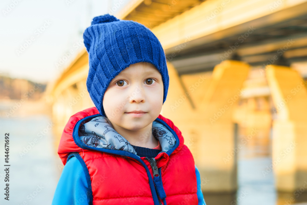 The boy in the blue cap and a red jacket