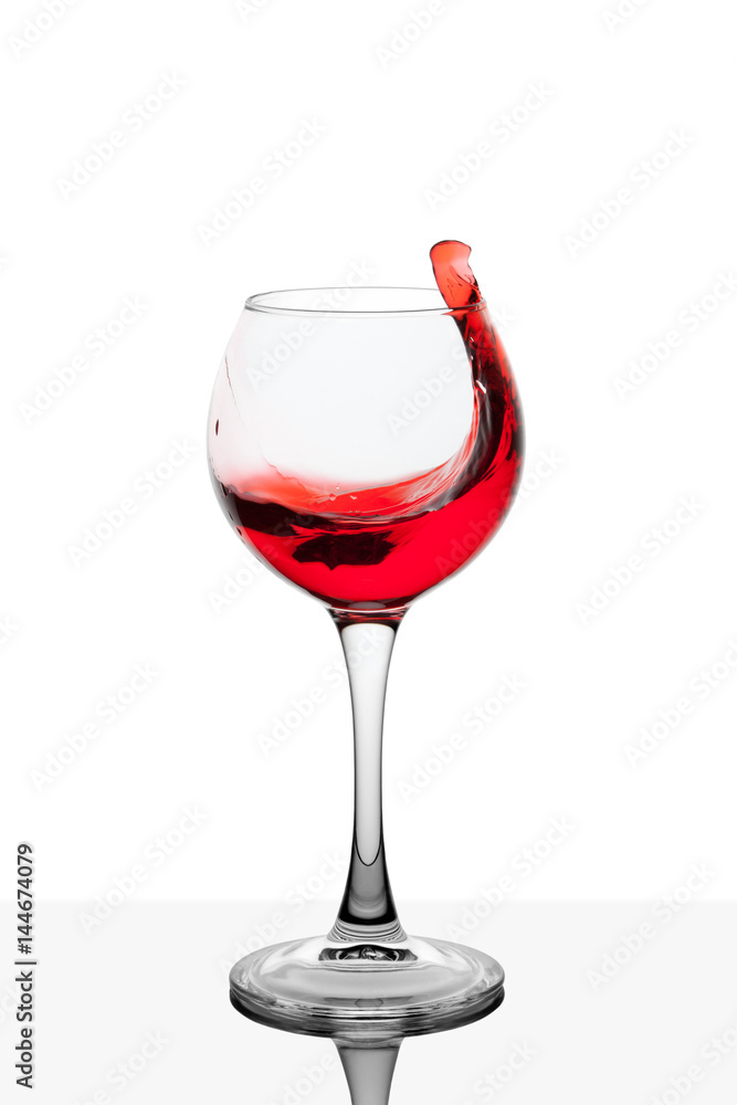 Splash of red wine in the cup filling on a white background Splash of red wine in the cup filling on a white background