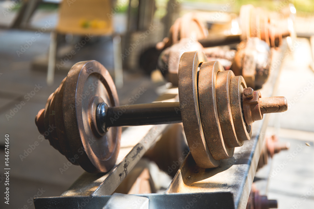 Rows of metal dumbbells on rack in the gym,Weight Training Equipment.