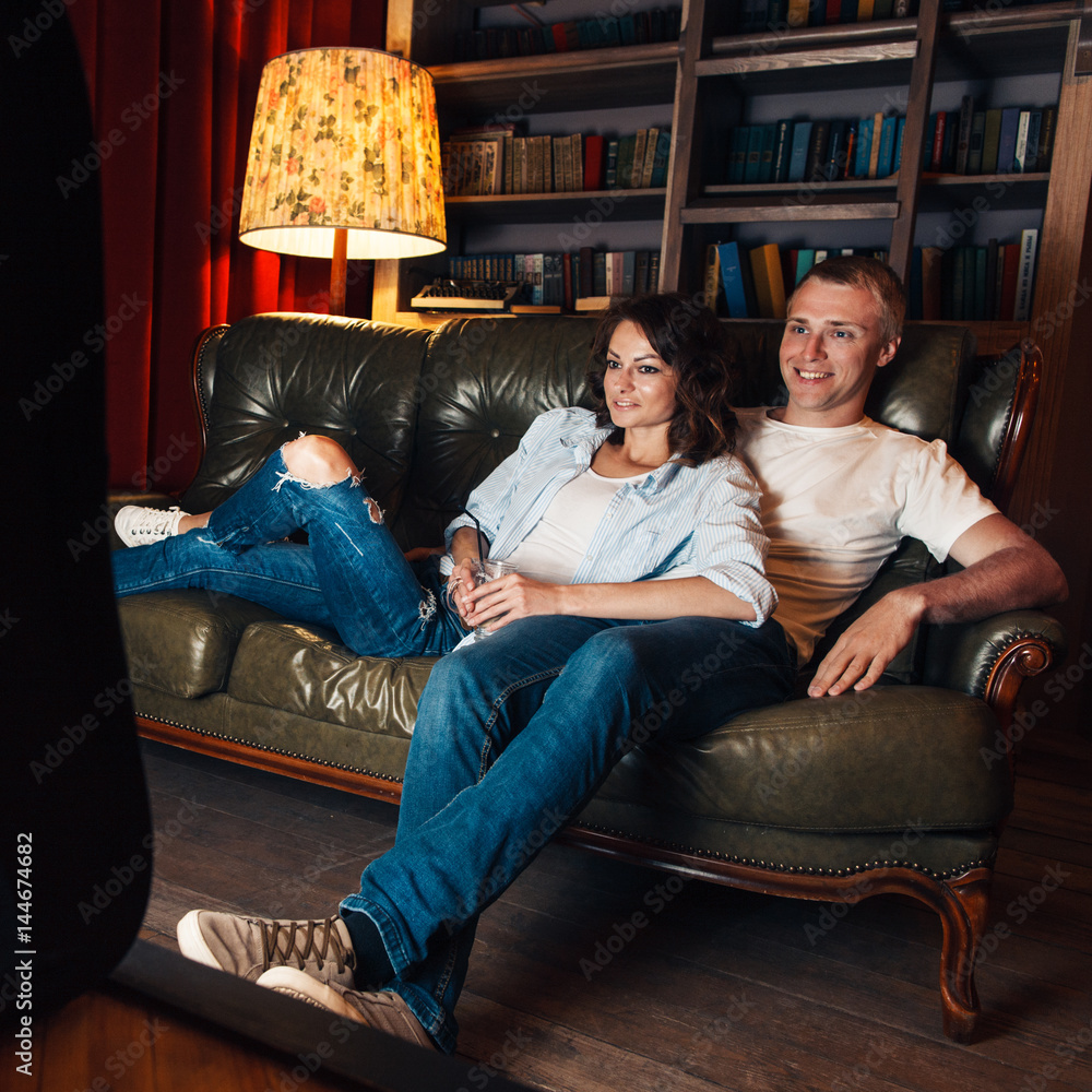 Young nice couple watch comedy movie at home tv on couch. Leisure, smiling, funny  moments, positive emotions concept Stock Photo | Adobe Stock