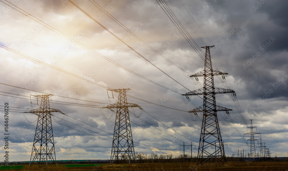 Electricity pylons and lines at dusk at sunset. Electricity pylons and lines at dusk at sunset.