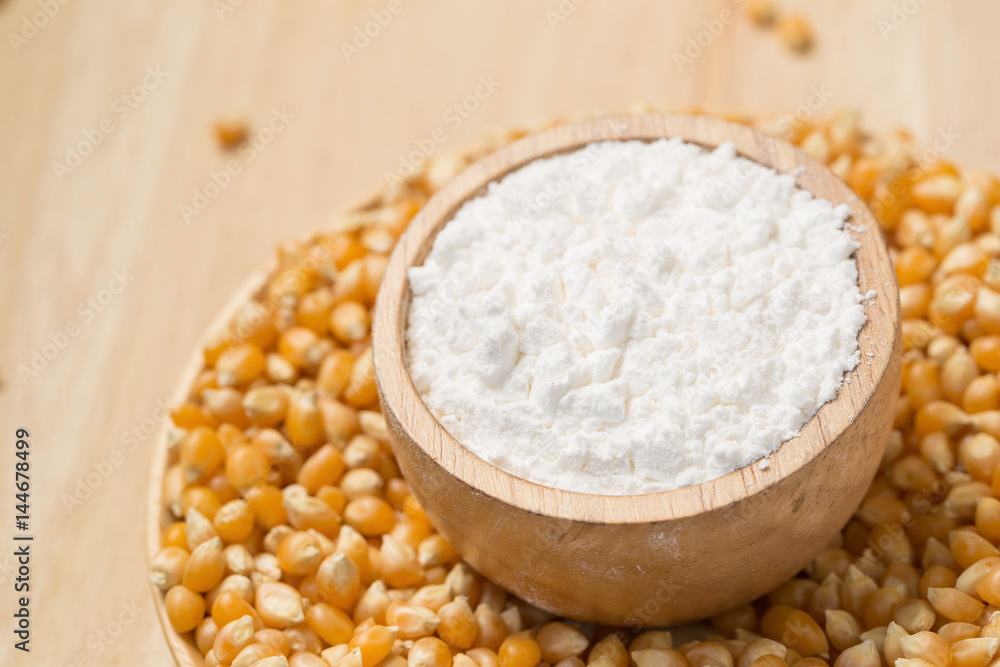 Corn flour in a bowl over a wooden table Corn flour in a bowl over a wooden table