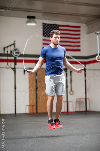 Fit athletic young man using a skipping rope
