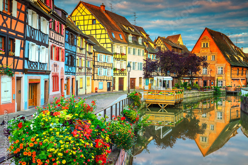 Famous medieval half-timbered facades reflecting in water, Colmar, France