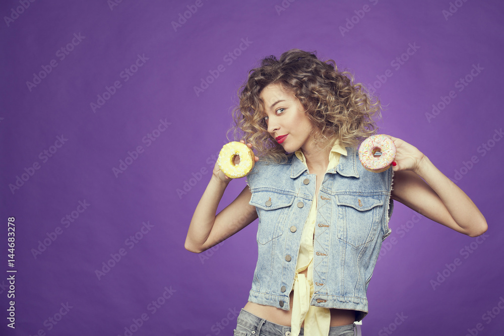 girl on a purple background holding a donut girl on a purple background holding a donut