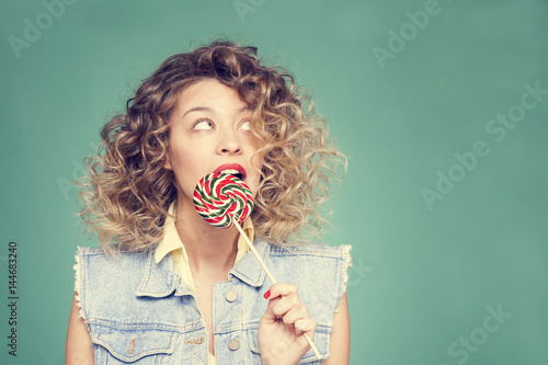 girl licks Lollipop and looking up
