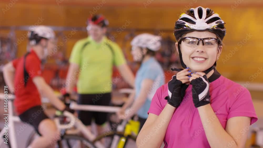 Portrait of cheerful young cyclist standing beside the track in velodrome Portrait of cheerful young cyclist standing beside the track in velodrome