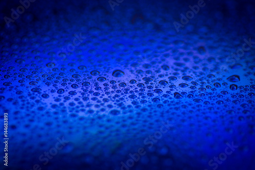 closeup to water drops on glass with lighting background