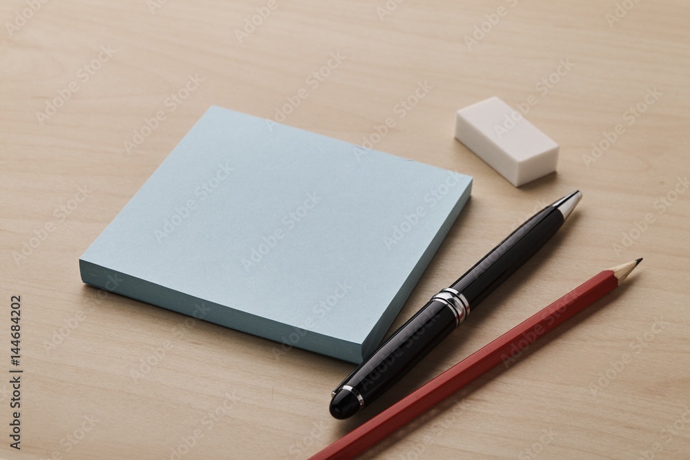 Note with pen, pencil and eraser Note with pen, pencil and eraser