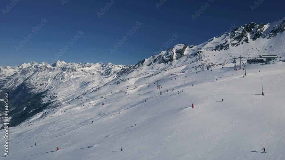 Scenic winter aerial flight of drone over the cable car and ski resort. Beautiful panorama, sunny day on ski resort. Obergurgl, Austria. 4K. Scenic winter aerial flight of drone over the cable car and ski resort. Beautiful panorama, sunny day on ski resort. Obergurgl, Austria. 4K.