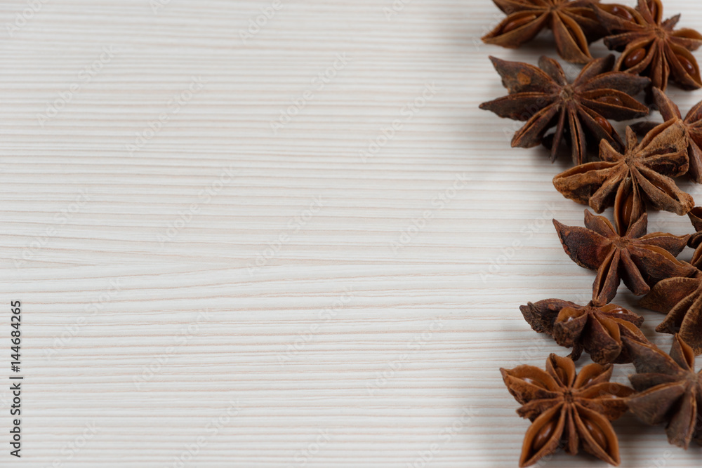 Star anise on white wooden background.