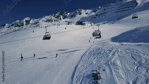 Scenic winter aerial flight of drone over the cable car and ski resort. Beautiful panorama, sunny day on ski resort. Obergurgl, Austria. 4K.