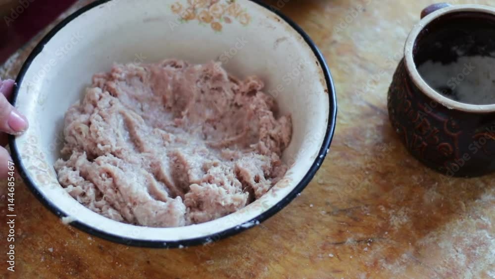 Hands are stirring minced meat in a bowl Hands are stirring minced meat in a bowl