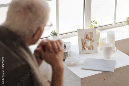 Selective focus of a photo standing on the bedside table