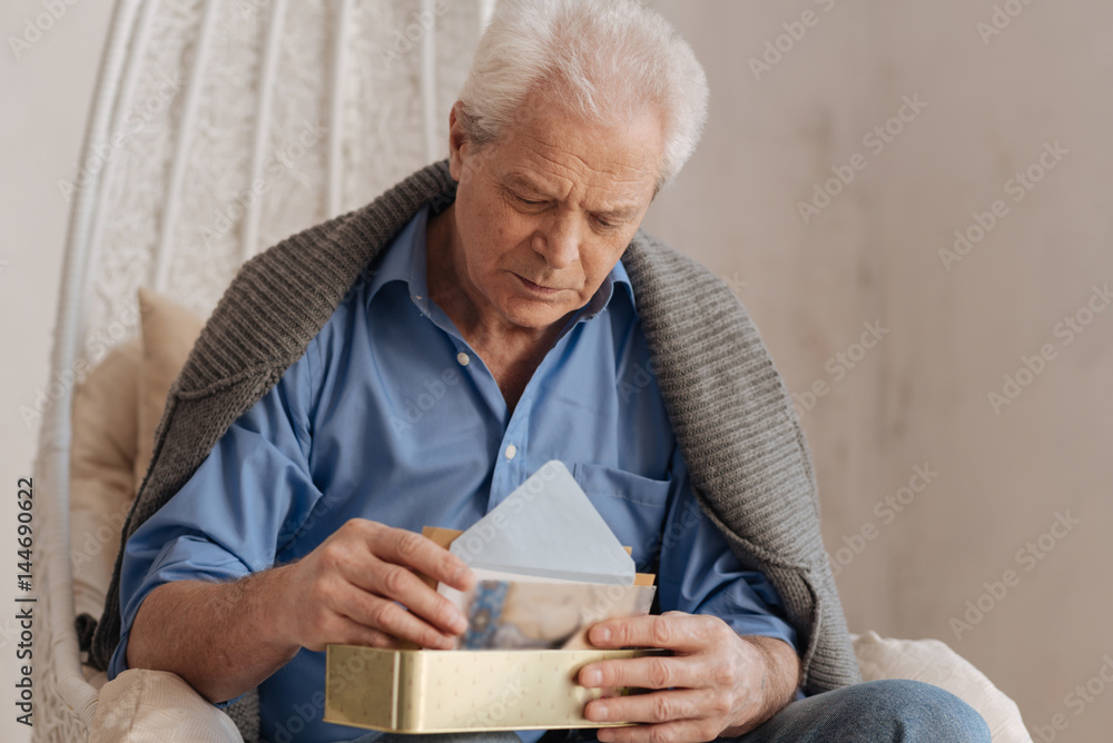 Moody cheerless man putting his letters in a box Moody cheerless man putting his letters in a box