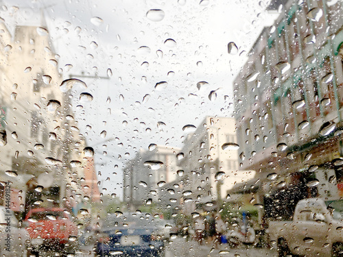 soft focus of Water drops on car glass with traffic jam background, traffic jam in Songkran Festival day.