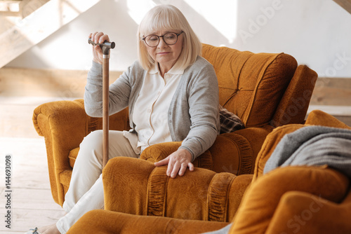 Картината върху платно Depressed aged woman grieving about her husband