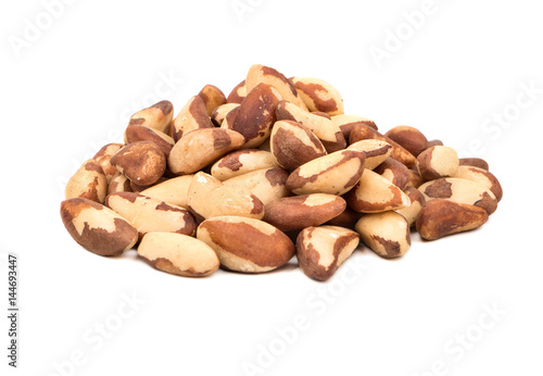 Large pile of raw Brazil nuts on white background