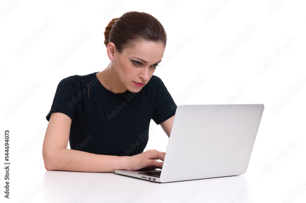 woman working on her laptop at the desk woman working on her laptop at the desk