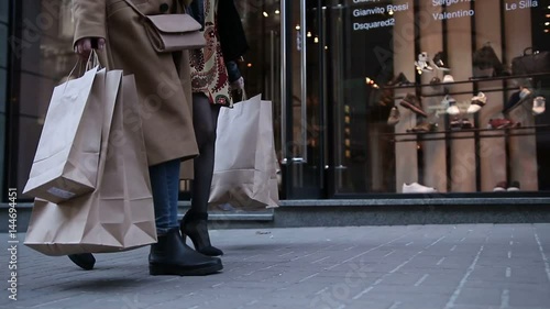 Young women walking with bags after shopping photo