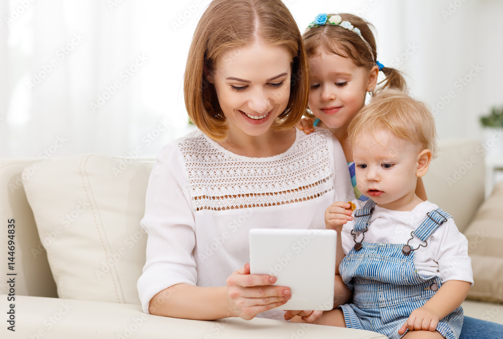 Mother and children with a tablet computer at home Mother and children with a tablet computer at home