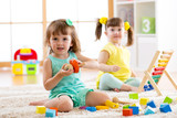 Adorable children playing colorful toys