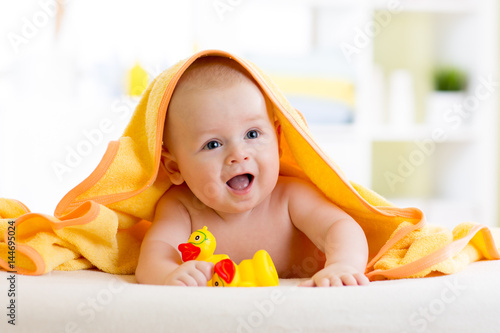 Cute baby with toys under a...