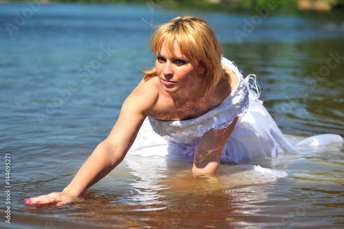 Girl in a wedding dress in water