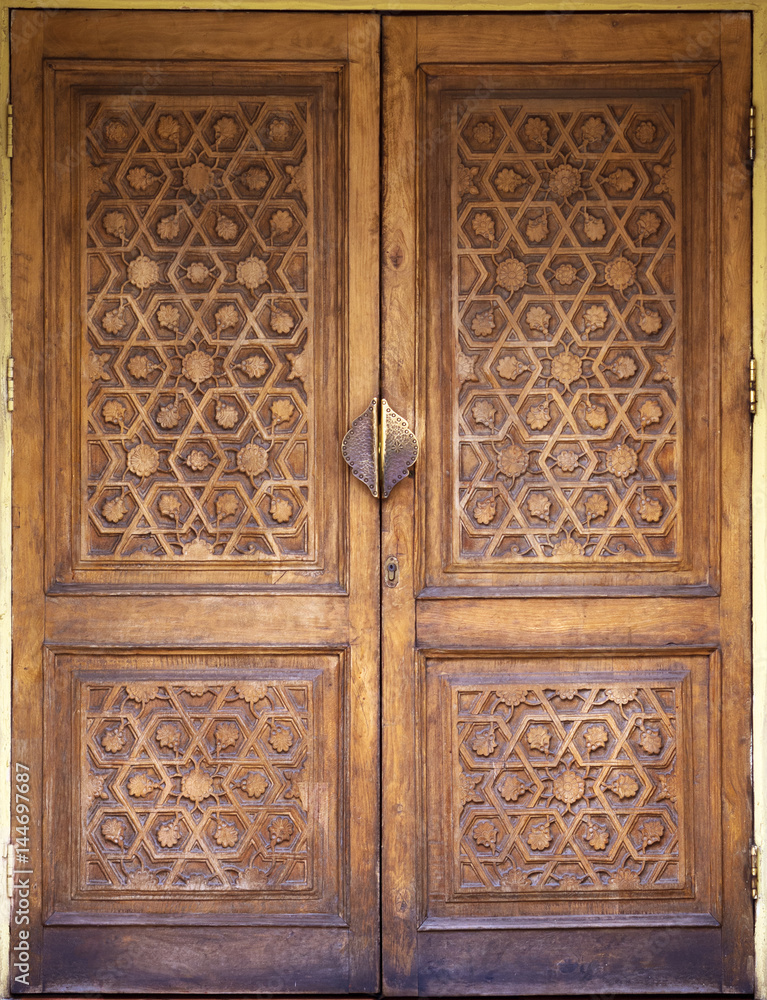 wooden door with beautiful carved pattern in Oriental style wooden door with beautiful carved pattern in Oriental style
