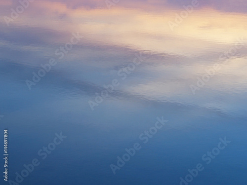 Abstract background of sunrise sky reflection on water surface.