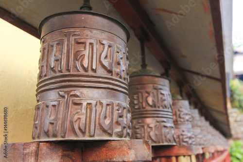 Metal prayer wheels for meditation and praying, from Buddhism Tibetan monastery in countryside of Nepal