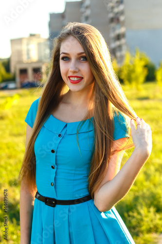 Portrait of attractive young woman in a city outdoors at sammer day/ photo