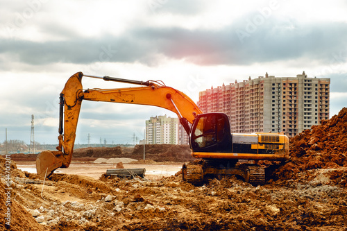 yellow excavator working on sand, the road construction