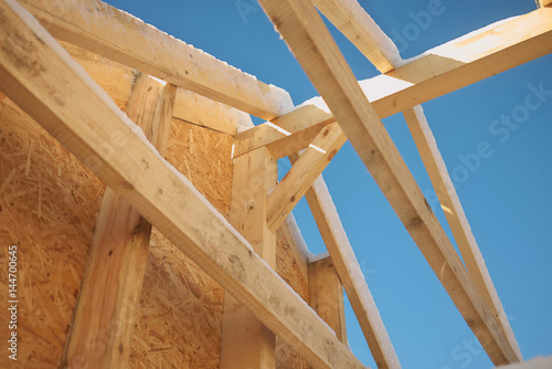 New home roof construction with wooden house frame