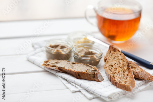 Bread with veal and rabbit pate with butter on a textile background. photo