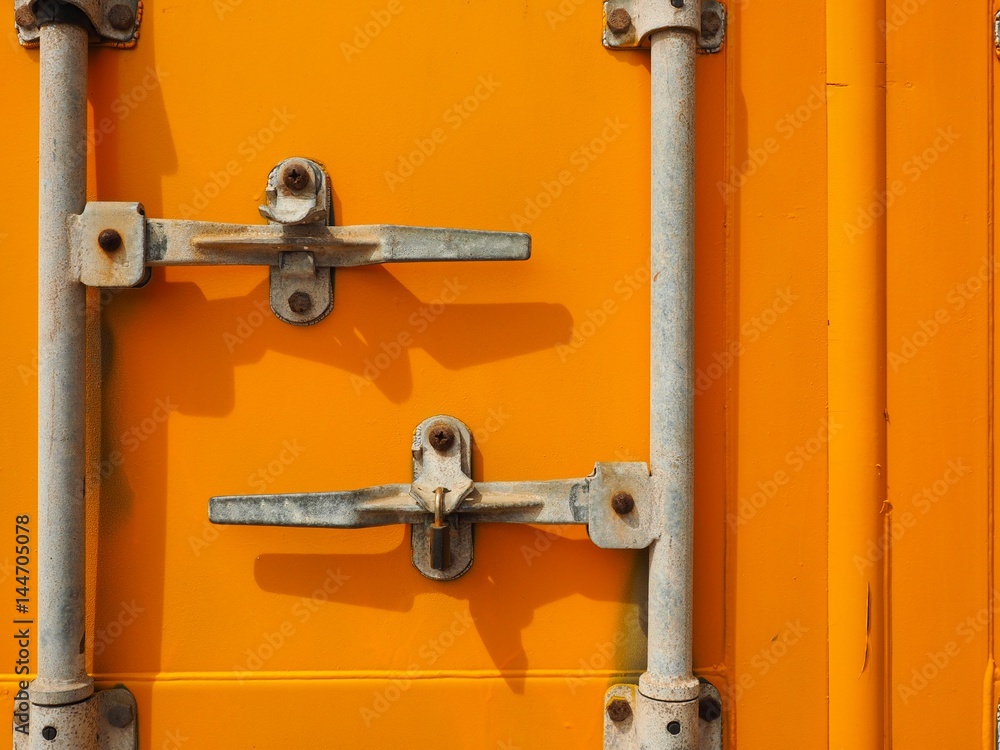 Yellow rusty container door on yard, yellow background Yellow rusty container door on yard, yellow background
