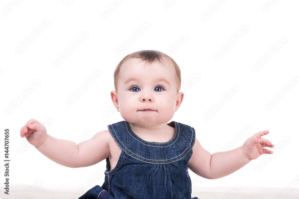portrait of cute baby girl with big blue eyes and long eyelashes, isolated on white. baby raises his arms up, smiling and looking into the camera portrait of cute baby girl with big blue eyes and long eyelashes, isolated on white. baby raises his arms up, smiling and looking into the camera