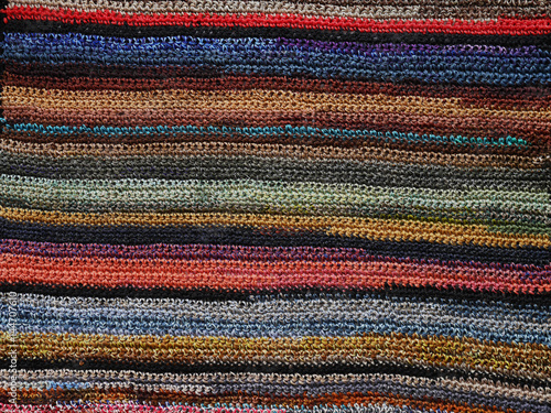 Abstract colored background. Knitted handmade rug.