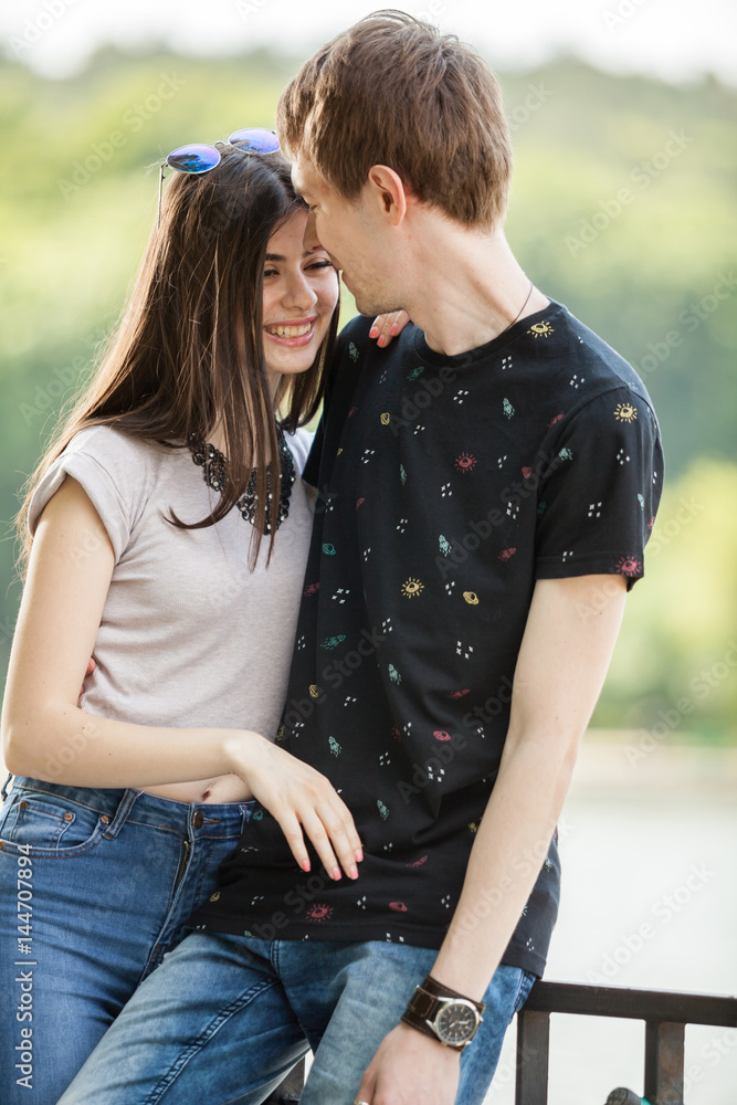 Fototapeta premium Caucasian couple taking a walk in the park. Lifestyle and relationship. Young inlove boyfriend and girlfriend