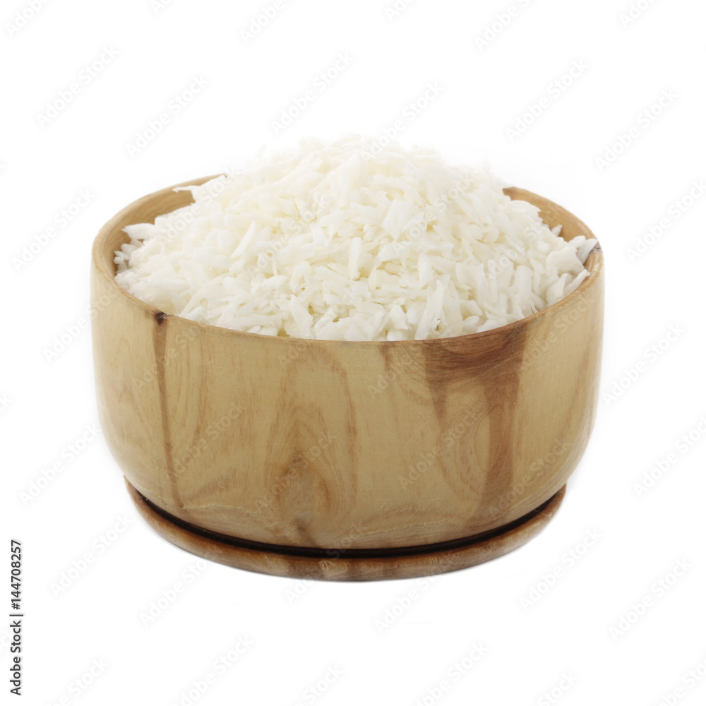 Dried grated coconut in wooden cup isolated on white background Dried grated coconut in wooden cup isolated on white background