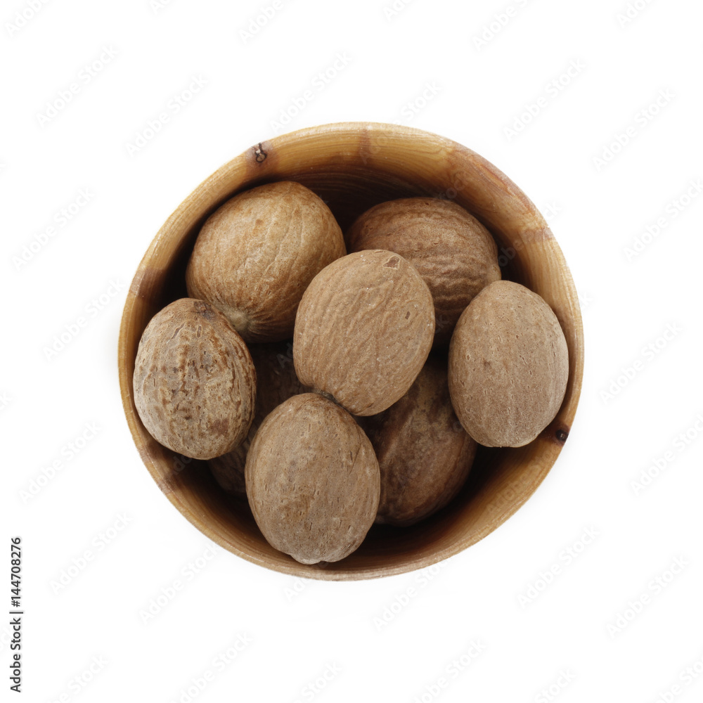 nutmegs in wooden cup isolated