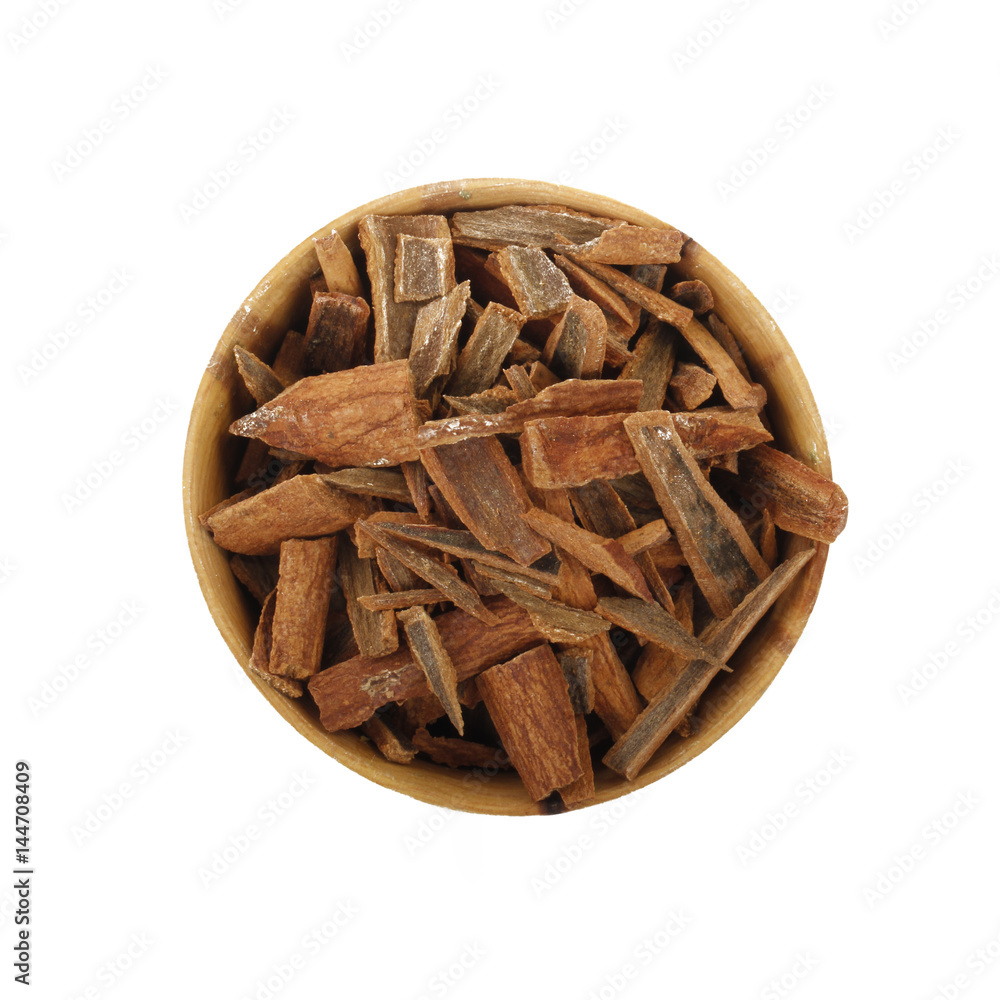 cinnamon (cassia) in wooden cup isolated on white background cinnamon (cassia) in wooden cup isolated on white background