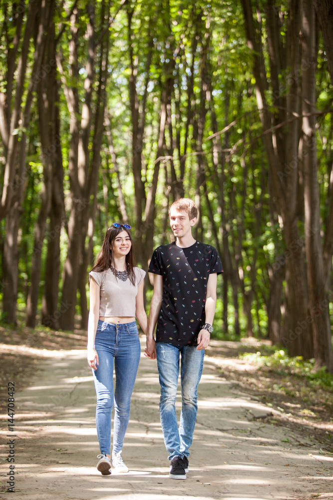 Couple taking a walk in the forest. Lifestyle and relationship. Young inlove boyfriend and girlfriend Couple taking a walk in the forest. Lifestyle and relationship. Young inlove boyfriend and girlfriend