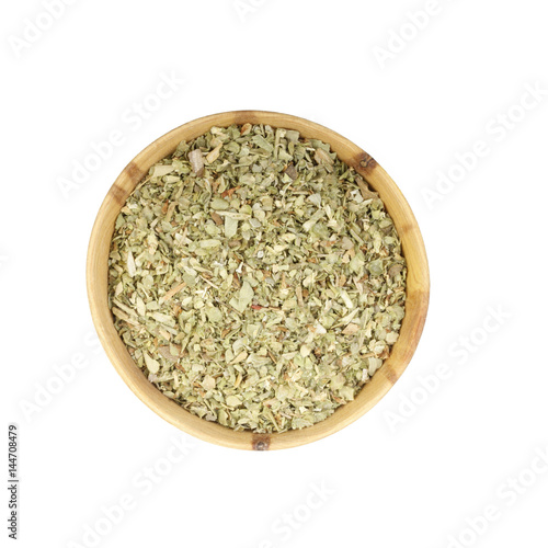 dried oregano in wooden cup isolated