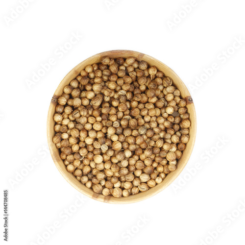 coriander in wooden cup isolated