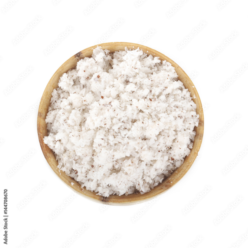 Dried grated coconut in wooden cup isolated on white background Dried grated coconut in wooden cup isolated on white background