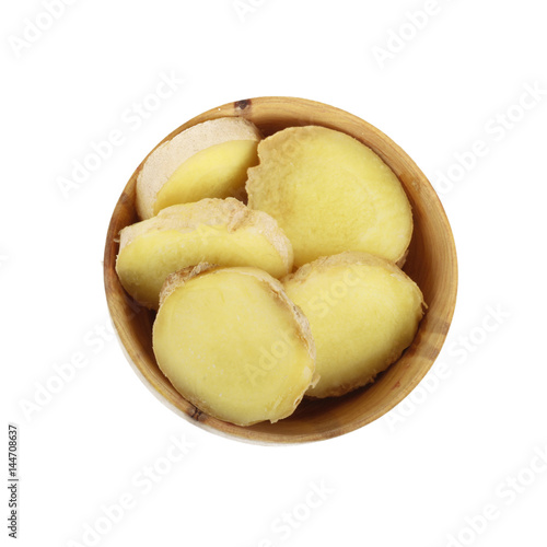 slices of ginger in wooden cup isolated