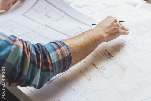 Hand of architect working with plans photo